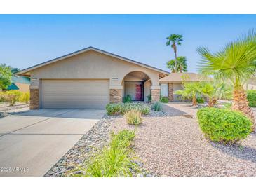 Charming single-story home with a well-maintained yard and a two-car garage at 10543 E Sahuaro Dr, Scottsdale, AZ 85259