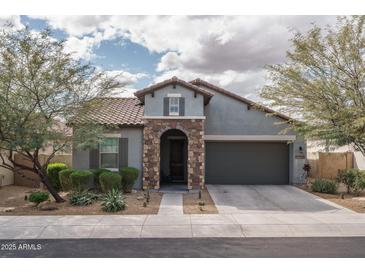 Charming single-story home with a stone-accented entryway and low-maintenance desert landscaping at 12158 S 184Th Ave, Goodyear, AZ 85338