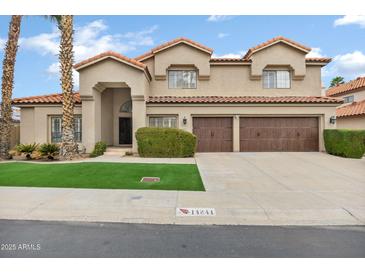 Charming two-story home featuring a well-manicured lawn, tile roof, and inviting curb appeal at 14841 N 62Nd Way, Scottsdale, AZ 85254