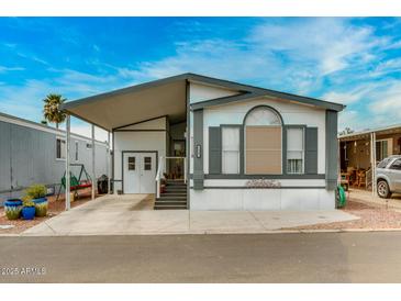 Inviting single-level home features a covered carport and well-manicured landscaping at 17200 W Bell Rd # 1643, Surprise, AZ 85374
