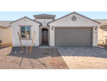 Charming single-story home featuring a stylish two-car garage and inviting front entrance at 21296 N 270Th Ln, Buckeye, AZ 85396