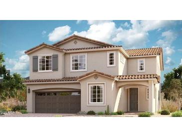 Charming two-story home featuring a tile roof, arched entryway, and a spacious two-car garage at 21830 E Bonanza E Ct, Queen Creek, AZ 85142