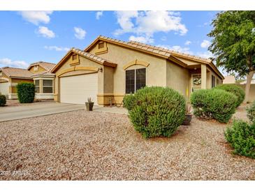Charming single-story home featuring a well-maintained front yard, two car garage, and tile roof at 2727 S Sawyer Cir, Mesa, AZ 85209