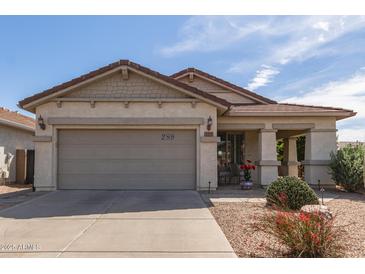 Charming single-story home featuring a low-maintenance desert landscaped front yard and attached two-car garage at 289 W Ironhorse Ln, San Tan Valley, AZ 85143
