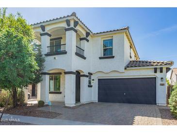 Two story home with a well manicured lawn and beautiful desert landscaping in front at 3129 E Franklin Ave, Gilbert, AZ 85295