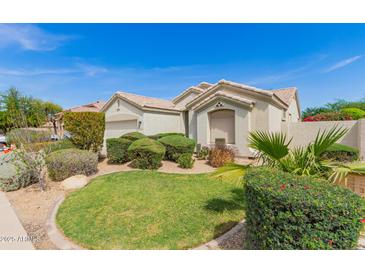 Inviting home featuring desert landscaping and a well-manicured lawn at 3871 S Marion Way, Chandler, AZ 85286