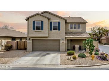 Charming two-story home featuring a desert landscape, two-car garage, and cozy covered porch at 4415 E High Point Dr, Cave Creek, AZ 85331