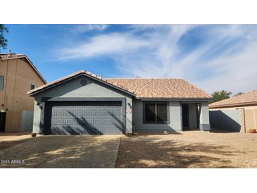 Charming single-story home with a two-car garage and desert landscaping on a sunny day at 444 W Fabens Ln, Gilbert, AZ 85233