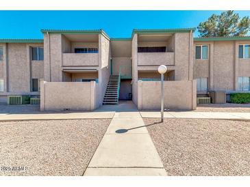 Cozy apartment complex showcasing its well-maintained exterior, with a nice walkway and stairs to the upper units at 623 W Guadalupe Rd # 214, Mesa, AZ 85210