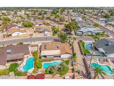 Beautiful aerial shot of a neighborhood, featuring a home with a private pool and well-maintained backyard at 6608 S Willow Dr, Tempe, AZ 85283