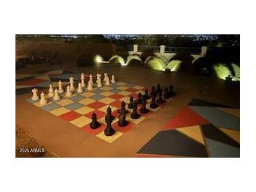 Outdoor game area with a giant chess set and landscaped surroundings, perfect for entertaining at 1932 E Beck Ln, Phoenix, AZ 85022