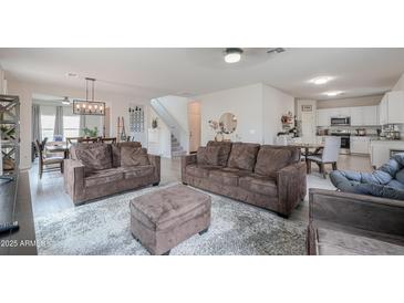 Bright and spacious living room with plush sofas, a soft rug, and an open layout at 45108 W Zion Rd, Maricopa, AZ 85139