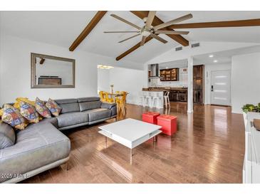 Bright living room showcasing a gray couch, ceiling fan, hardwood floors, and a modern design at 6747 N 12Th St, Phoenix, AZ 85014