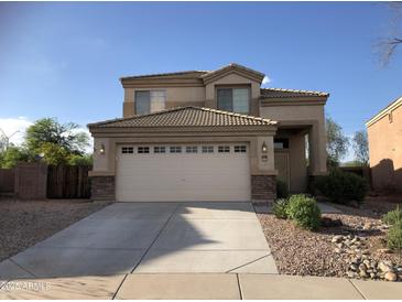 Inviting two-story home featuring desert landscaping, a two-car garage, and a neutral color palette at 23236 W Yavapai St, Buckeye, AZ 85326