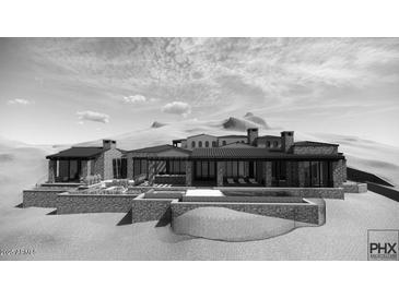 A sprawling modern home with dark trim boasts floor-to-ceiling windows and stone accents, showcasing luxury desert living at 11130 E Rolling Rock Dr, Scottsdale, AZ 85262