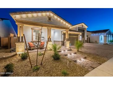 Charming single-Gathering home featuring a welcoming front porch and desert landscaping at 13941 W Tierra Grande --, Surprise, AZ 85387