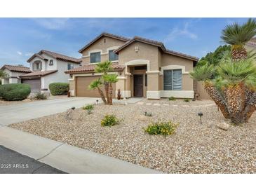 Beautiful two-story home featuring desert landscaping, attached garage, and covered entryway at 15962 W Statler St, Surprise, AZ 85374