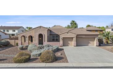 Charming single-story home boasting a spacious three car garage and well maintained desert landscaping at 2894 E Nolan Pl, Chandler, AZ 85249