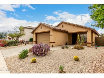 Charming single-story home featuring xeriscape front yard and attached two-car garage at 43142 N Outer Bank Dr, Anthem, AZ 85086