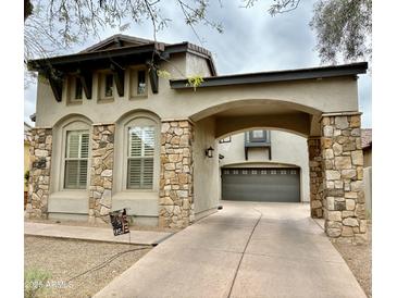Beautiful two-story home featuring a neutral color scheme and stone accents on the facade and porte-cochere at 9285 E Canyon Vw, Scottsdale, AZ 85255