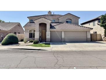 Charming two-story home boasts a stylish facade, tiled roof and an arched entryway at 2461 E Binner Dr, Chandler, AZ 85225