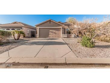 Single-story home featuring a well-maintained front yard and a spacious two-car garage at 2738 E Silversmith Trl, San Tan Valley, AZ 85143