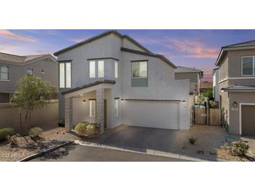 Beautiful two-story home featuring a two car garage and a low maintenance front yard at 15837 N 74Th Ln, Peoria, AZ 85382