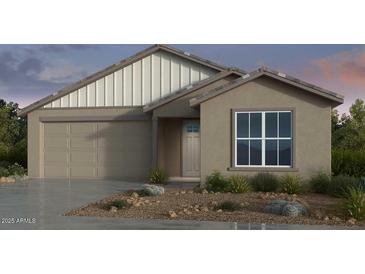Charming single-story home with a neutral color palette, well-manicured landscaping, and an attached two-car garage at 17153 W Sweet Iron Pass, Surprise, AZ 85387