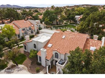 Scenic aerial view of charming residences with terracotta roofs nestled amidst lush greenery and community green spaces at 1717 E Union Hills Dr # 1110, Phoenix, AZ 85024