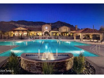 Resort-style community pool with stunning mountain views and a beautiful fountain feature at 2041 N 88Th St, Mesa, AZ 85207