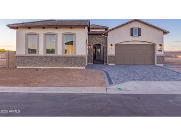 Beautiful single-story home with a brick-accented facade, paver driveway, and a welcoming entrance at 2636 E Virginia St, Mesa, AZ 85213