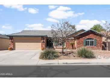 Charming single-story brick home featuring a two-car garage and low-maintenance desert landscaping at 40020 N Cape Wrath Dr Dr, San Tan Valley, AZ 85140