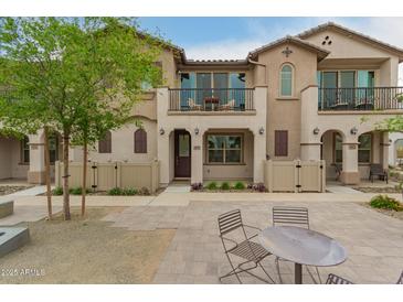 Charming townhome with private patios and neutral-toned stucco and tile roofing at 4657 S Vapor --, Mesa, AZ 85212