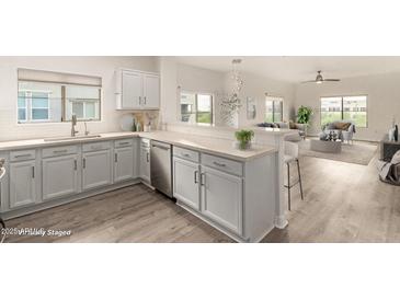 Bright kitchen featuring modern appliances, light wood floors, and stone countertops at 5450 E Deer Valley Dr # 3023, Phoenix, AZ 85054
