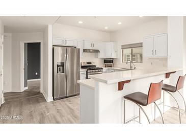 Well-equipped kitchen with stainless steel appliances, breakfast bar, and ample counter space at 5450 E Deer Valley Dr # 3023, Phoenix, AZ 85054