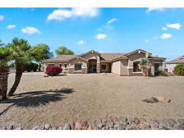Charming single-story home with desert landscaping, a tile roof, and tan stucco exterior at 9722 W Prospector Dr, Queen Creek, AZ 85144