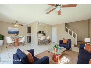 Comfortable living room featuring modern furnishings, cozy seating, and a stylish ceiling fan at 4614 E Pueblo Ave, Phoenix, AZ 85040