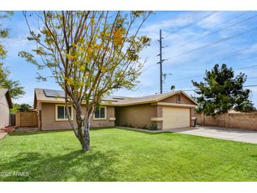 Charming single-story home featuring a well-manicured lawn and a two-car garage at 18601 N 45Th Dr, Glendale, AZ 85308