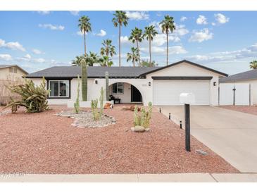 Charming single-story home featuring desert landscaping and a two-car garage, offering curb appeal at 2026 S Emerson --, Mesa, AZ 85210