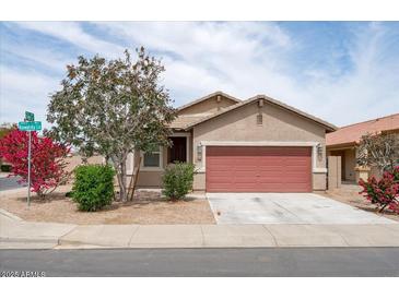Charming single-story home featuring a two-car garage and desert landscaping at 24868 W Kowalsky Ln, Buckeye, AZ 85326