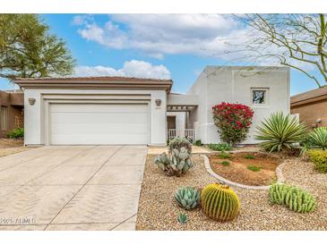Charming single-story home featuring a two-car garage and low-maintenance desert landscaping at 32771 N 70Th St, Scottsdale, AZ 85266
