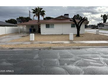 Charming single-story home featuring a palm tree and a covered parking area at 4701 N 39Th Dr, Phoenix, AZ 85019