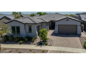 Charming single-story home with a beautiful tile roof, landscaping, and brick driveway at 9903 E Rotation Dr, Mesa, AZ 85212