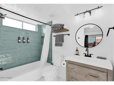 Charming bathroom with updated vanity, modern fixtures, and tiled shower/tub, offering a refreshing and functional space at 413 E Linda Ln # D, Gilbert, AZ 85234