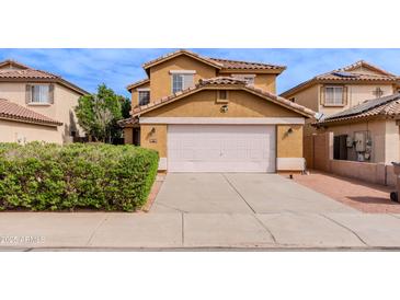 Two-story home featuring a white garage door and neutral color scheme, complemented by a well-maintained lawn at 1096 E Rolls E Rd, San Tan Valley, AZ 85143