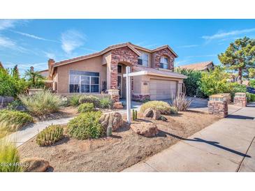 Charming two-story home features a landscaped yard, stone accents, and a spacious garage at 15009 S 47Th St, Phoenix, AZ 85044