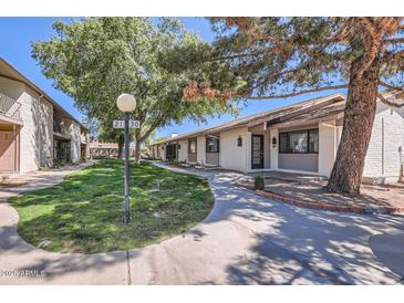 Charming single-story home with well-maintained landscaping and a welcoming walkway at 1550 N Stapley Dr # 21, Mesa, AZ 85203
