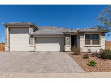 Charming single-story home featuring a three-car garage and desert landscaping at 1644 E Joelle Dr, Casa Grande, AZ 85122