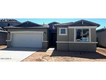 Single-story home featuring a gray exterior, attached two-car garage and low maintenance desert landscaping at 19039 W Rose Ln, Waddell, AZ 85355