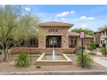 Elegant clubhouse entrance with stone accents, fountain and manicured landscaping, plus visible fire lane at 20100 N 78Th Pl # 2203, Scottsdale, AZ 85255